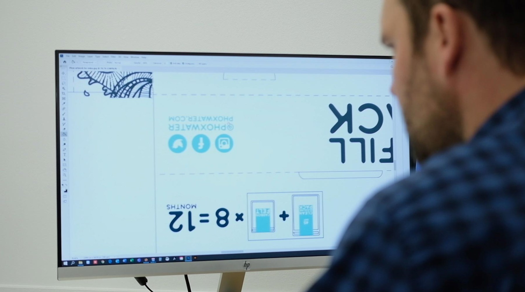 Graphic Designs on screen with a designer editing them